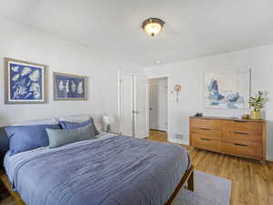 Bedroom with light wood finished floors and baseboards