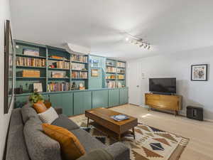 Living room with light wood-style floors and a textured ceiling