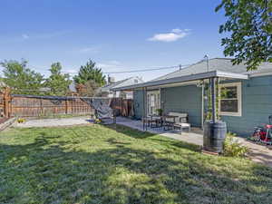 Fenced yard featuring a patio