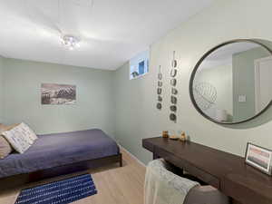 Bedroom with wood finished floors and baseboards