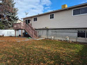 Rear view of property with a wooden deck and stairs