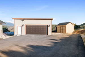 Detached garage with a mountain view and a storage shed