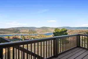 Wooden deck with a water and mountain view