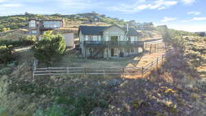 Rear view of house featuring stairs, a fenced backyard, and a deck