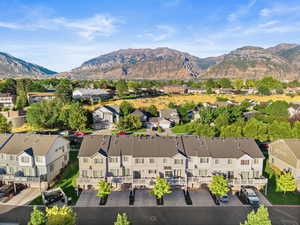 Aerial perspective of suburban area featuring a mountain backdrop