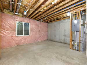 Unfinished below grade area featuring electric panel