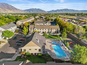Aerial view of residential area with a mountainous background and a pool