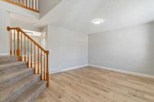 Foyer entrance featuring light wood-type flooring and stairway