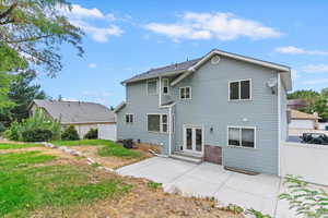 Rear view of property featuring a patio and french doors