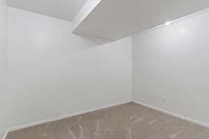 Unfurnished room with carpet flooring and baseboards