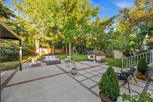 Fenced backyard with an outdoor hangout area and a patio