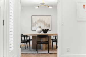 Dining area featuring light wood finished floors and ornamental molding
