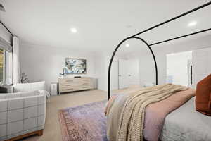Carpeted bedroom featuring recessed lighting and ornamental molding