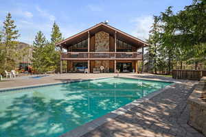 Community pool with a patio area and a balcony