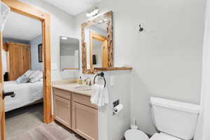 Bathroom with vanity, ensuite bath, light wood-style floors, and curtained shower