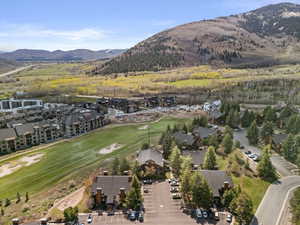 Aerial view of property's location with mountains and nearby suburban area