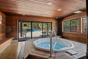 View of pool with a hot tub