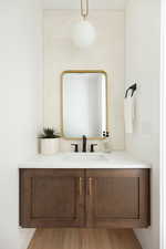 Bathroom with wood finished floors and vanity