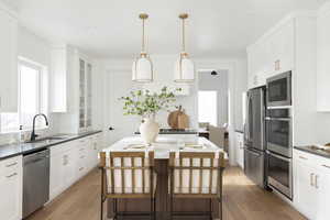 Kitchen with white cabinetry, light wood-type flooring, and recessed lighting