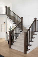 Staircase featuring wood finished floors