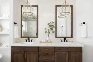 Full bathroom featuring double vanity and a walk in shower