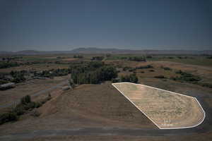 Aerial overview of property's location with property parcel outlined and rural landscape