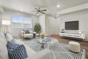 Living area with wood finished floors, recessed lighting, ceiling fan, and wooden walls