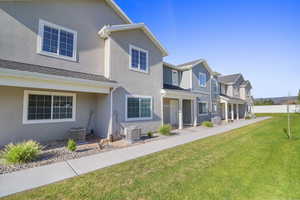 View of front of home featuring a front lawn, stucco siding, a porch, and a residential view