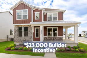 View of front of house with covered porch, a metal roof, board and batten siding, and a standing seam roof