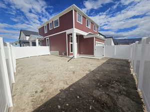 Back of property with a fenced backyard and a mountain view