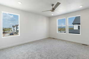 Unfurnished room featuring light colored carpet, recessed lighting, and ceiling fan