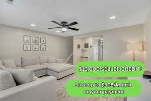 Living area with recessed lighting, stairway, and a ceiling fan