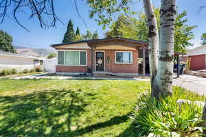 Bungalow-style house featuring a front lawn and brick siding