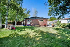 Rear view of property featuring brick siding and a patio
