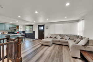 Living room with recessed lighting and light wood-style floors