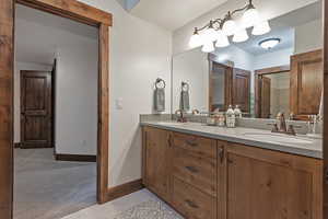 Bathroom with double vanity and light tile patterned floors