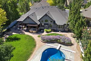 Back of house with a patio, a shingled roof, a fenced backyard, and stucco siding