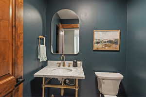 Half bathroom featuring toilet and a sink