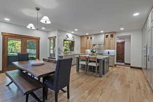 Dining space with light wood-type flooring and recessed lighting