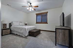Carpeted bedroom featuring baseboards and a ceiling fan
