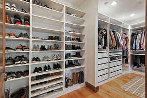 Spacious closet with light wood-style flooring