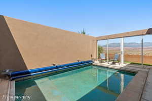 View of pool featuring a mountain view and a covered pool
