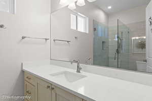Bathroom with vanity and a shower stall