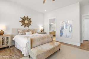 Bedroom with wood finished floors, recessed lighting, ceiling fan, and ensuite bath