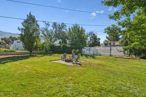 Fenced backyard with a patio and a fire pit