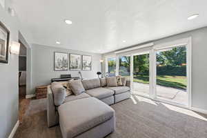 Living area featuring recessed lighting and a textured ceiling