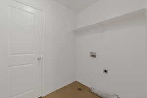 Laundry area featuring hookup for a washing machine, hookup for an electric dryer, and light tile patterned floors