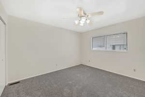Primary bedroom upstairs with new carpet and ceiling fan