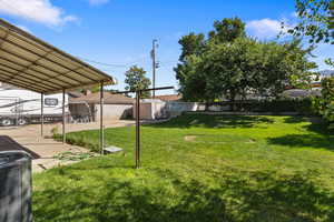 Fenced backyard with a storage shed