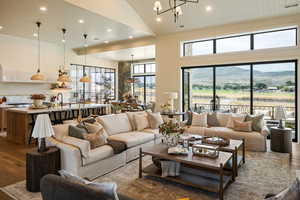 Living room featuring recessed lighting, dark wood-style flooring, a chandelier, high vaulted ceiling, and a mountain view
